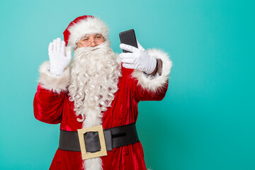 Santa Claus having a video call using smart phone