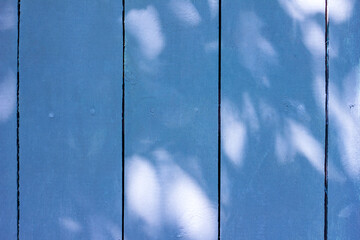 Wooden planks background tinted with the color of the year 2020 classic blue