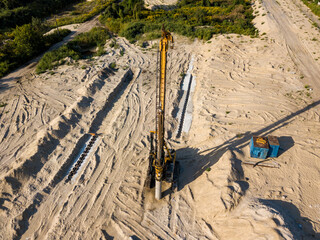 Aerial drone view. Drilling machine on a bridge construction site.