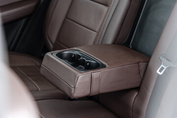 Obraz na płótnie Canvas a back seat elbow pad wit cup holder ob a modern car