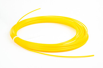 Top view of yellow rolled filament plastic for 3D Printing Pen isolated on white. - obrazy, fototapety, plakaty