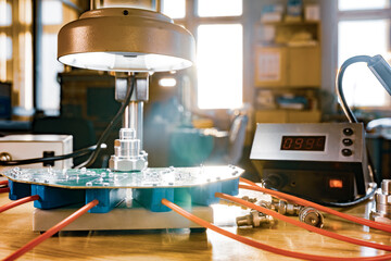 Modern microscope, connectors component and large green microcircuit in workshop laboratory