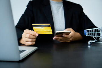 Businesswoman hand using mobile smart phone and creditcard, onlinepament, banking and online shopping at the home office.