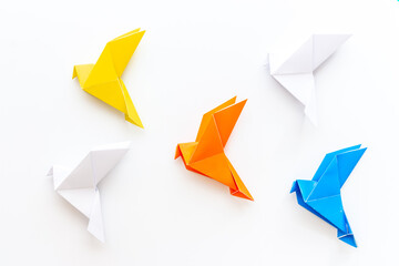 Paper birds of different shades. Origami concept. Top view - obrazy, fototapety, plakaty