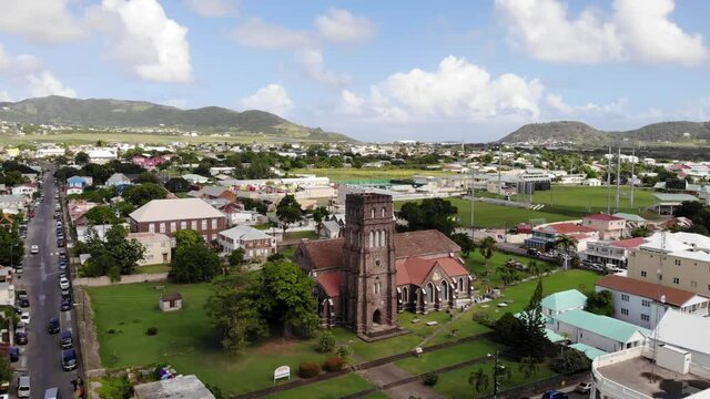 Basseterre / St. Kitts & Nevis - December 2019: Aerial shot of Saint George with Saint Barnabas Anglican Church. Drone is moving away.