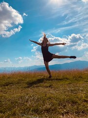 happy young woman jumping on the meadow
