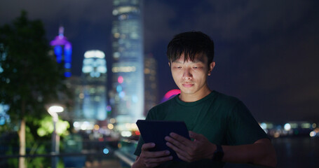 Man use of tablet computer at night
