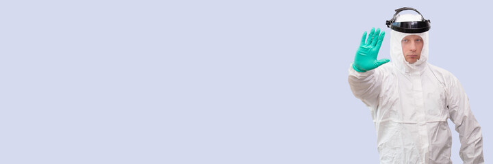 A doctor in a costume of a super hero stands on defense against a viral pandemic.