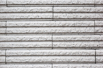White texture of ancient limestone wall with grooves.