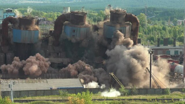 The collapse of an obsolete industrial chimney with an explosion. Disposal of an obsolete metallurgical plant.