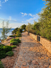stone path in the park next to a sea