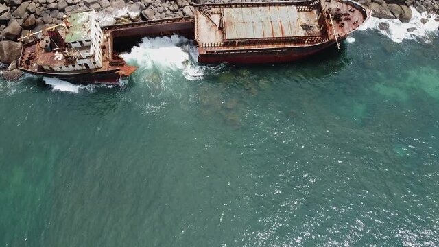 The rusty shipwreck run aground. Sri Lanka