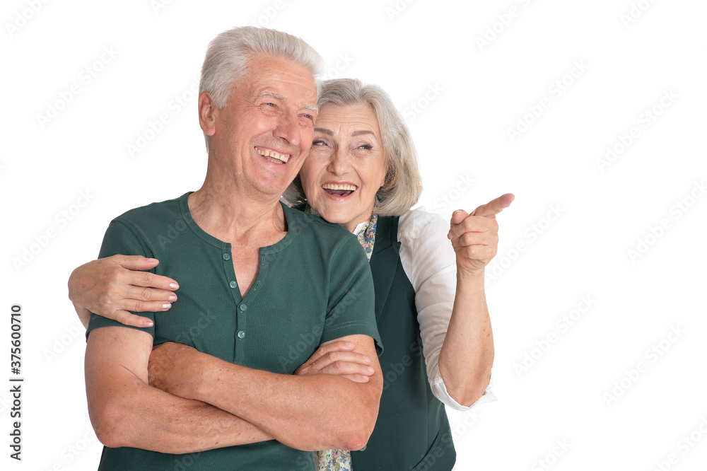 Poster Portrait of a happy senior couple pointing to the right