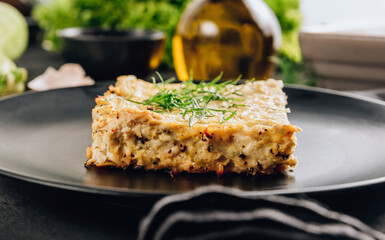 Zucchini casserole on dark background. Dietary, low-calorie, healthy food. Homemade Casserole from squash with chicken and eggs.