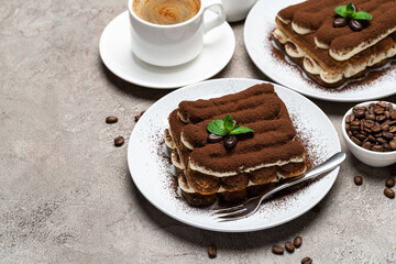 Classic tiramisu dessert, cup of coffee, sugar and milk on concrete background