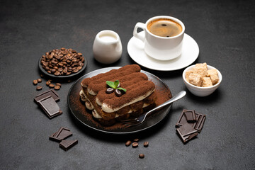 Classic tiramisu dessert, cup of coffee, sugar and milk on concrete background