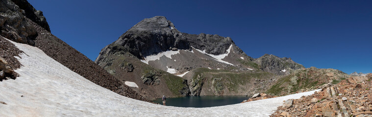 Man hiking in mountains. Hiking in Pyrenees National Park, Hautes-Pyrenees, Occitanie in south of France France