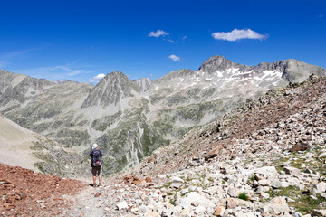 Man hiking in mountains. Hiking in Pyrenees National Park, Hautes-Pyrenees, Occitanie in south of France France