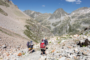Hikers walking in Pyrenees National Park, Hautes-Pyrenees, Occitanie in south of France