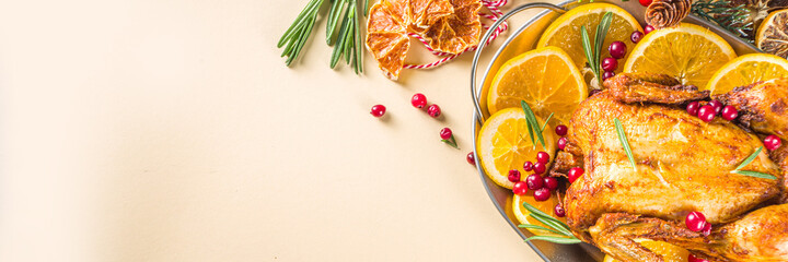 Traditional homemade Christmas chicken. Oven baked chicken with orange, cranberry rosemary and...