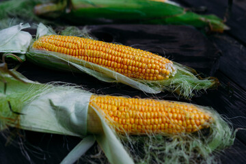 Yellow corn on the cob on a wooden table © elenavah