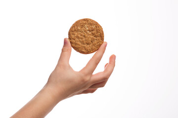 Little boy hand holding a whole grain cookie biscuit