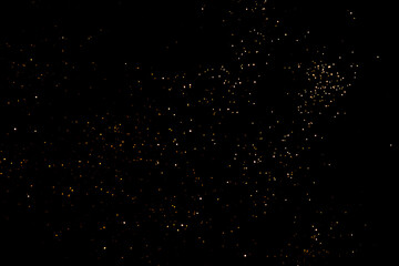 Golden abstract bokeh on black background. Holiday concept