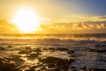 Waves breaking at sunset