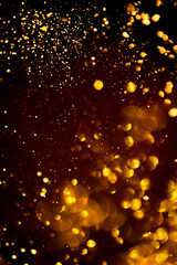 Golden abstract bokeh on black background. Holiday concept