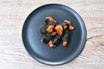fried salty chicken roll seaweed arranging on plate