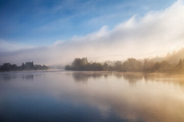 Landscape with a river in foggy morning. River Vah near Strecno village, Slovakia, Europe.