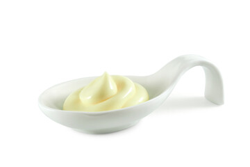 Mayonnaise or cream swirl in ceramic spoon isolated on white background side view
