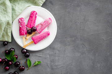 Cherry ice cream, berry popsicles on the table, top view