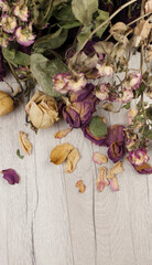 bouquet dried roses on old wood background with copy space
