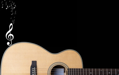 classic steel string acoustic guitar on a black background with white music notation