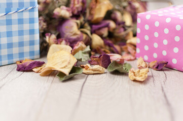 bouquet dried roses with gift box on old wood background with copy space