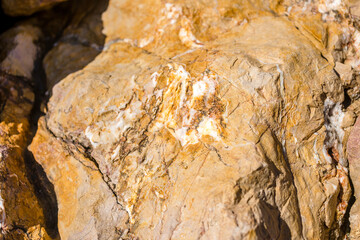 Closeup on rock rough natural mineral stone background, top view.