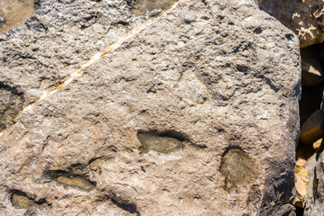 Closeup on rock rough natural mineral stone background, top view.
