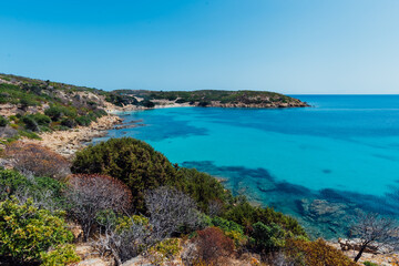 Fototapeta na wymiar Stunning view of Asinara coastilne bathed by a turquoise and transparent sea with no one in Sardinia, Italy