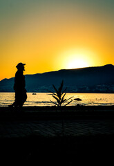 silhouette of a man walking on the beach