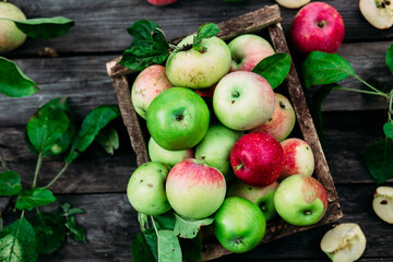 Ripe apples in a wooden box