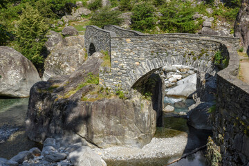 Fototapeta na wymiar Old bridge in Bavona valley on the Swiss alps