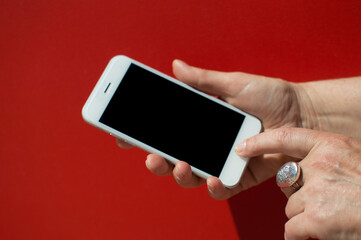 Female holding touch screen mobile phone, closeup.