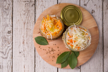 Sauerkraut in open glass mason jar. Pickling cabbage at home on table.Fermented food. Copy space. The best natural probiotic