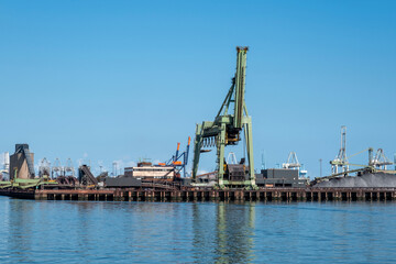Fototapeta na wymiar Coal terminal wih big industrial cranes for handling coal transportation on the Maasvlakte in the port of Rotterdam