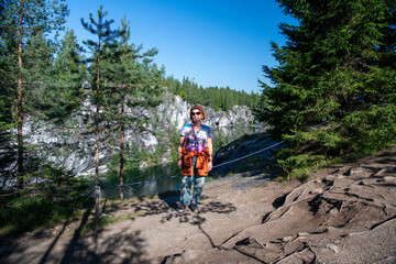 woman tourist on the background of a mountain north lake