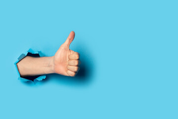 Male hand makes a hand up gesture on a blue background. Banner. Gesture all ok, like