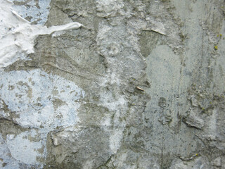 dirty rough concrete surface with scratches and scraps of ads, brutal and harsh background