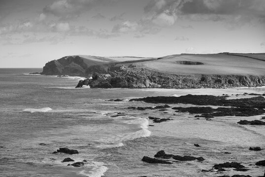 Monochrome image of beach and cliffs of the coast of North Cornwall