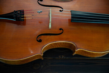 Fototapeta premium The cello lies on a wooden surface. Place for text